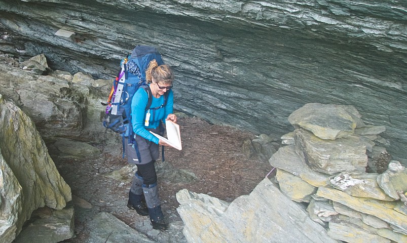 Ali checks out the Arawhata Rock Biv hut book